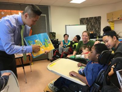 Assistant Principal Hoang Nguyen reads to an elementary class