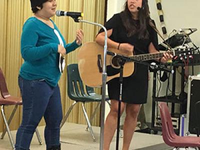 student, Jazmin, performs solo with music therapist MG Rivas-Berger accompanying on the guitar