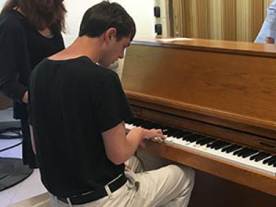 student, Jack, accompanies class on the piano
